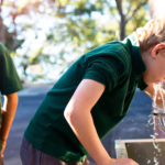 2 childs drinking school tap water