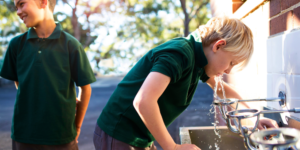 2 childs drinking school tap water