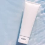 a white tube of cream on water