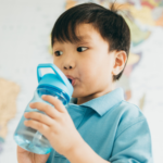 asian child drinking water