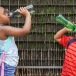 boy and girl drinking water at school