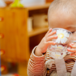 child at day care drinking water