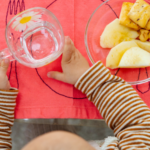 child at daycare drining water top view