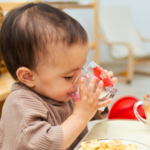child at daycare drinking water