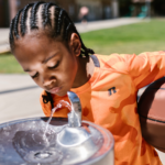child drinking school water