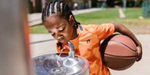 child drinking school water