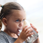 girl drinking glass of water