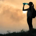 girl drinking water in nature