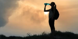 girl drinking water in nature