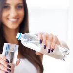 girl pouring water in a glass