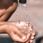 poor child drinking water