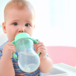 small child at daycare drinking water