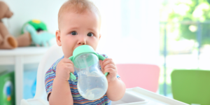 small child at daycare drinking water