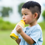 small child drinking water