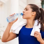 sport girl drinking water
