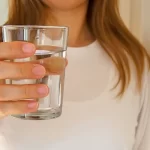 woman holdin a glass of water
