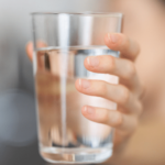 woman showing a lass of water