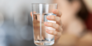 woman showing a lass of water