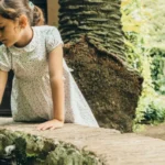 2 kids playing with public water