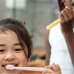 asian childs brushing teeth