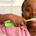 black child brushing teeth