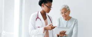 black woman doctor with old woman patient