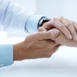 doctor checking patient hand