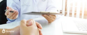 doctor holding a tablet speaking with patient