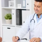 doctor showing results to indian patient