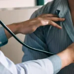 doctor using stethoscope to check hearth