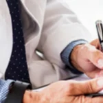 doctor writing on paper