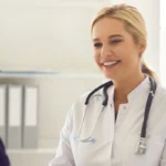 female doctor with stethoscope speaking with patient
