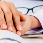 male doctor checking hand
