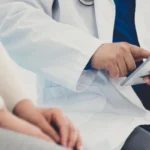 male doctor speaking with patient