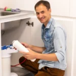 man changing water filter