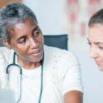 old black female doctor with patient