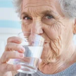 old woman drinking water
