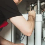 plumber changing water filter