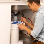 plumber changing water filter 3
