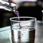 pouring water in 2 glasses