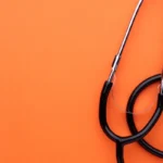 stethoscope on orange background