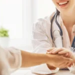 woman doctor checking patient hand