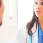 woman doctor speaking with male patient