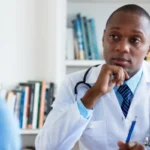 young black doctor with black patient