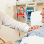 young doctor with old patient on bed