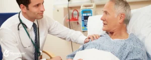 young doctor with old patient on bed