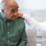 young male doctor with old patient