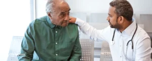 young male doctor with old patient