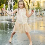 kids playing in public fountain