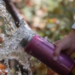 taking spring water with bottle 3